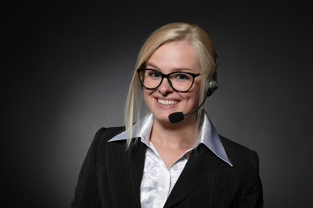 Coordinator wearing a phone headset, smiling
