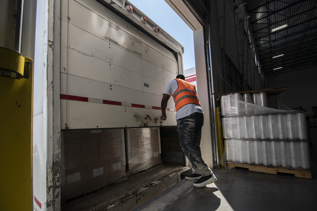 Worker in safety vest checking a trailer at the loading dock