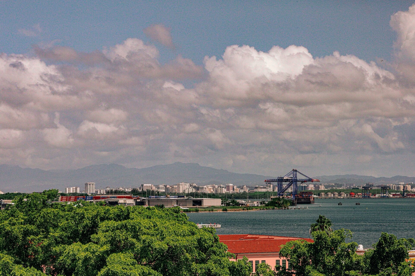 Gantry cranes and containers at the Port of San Juan against the bay