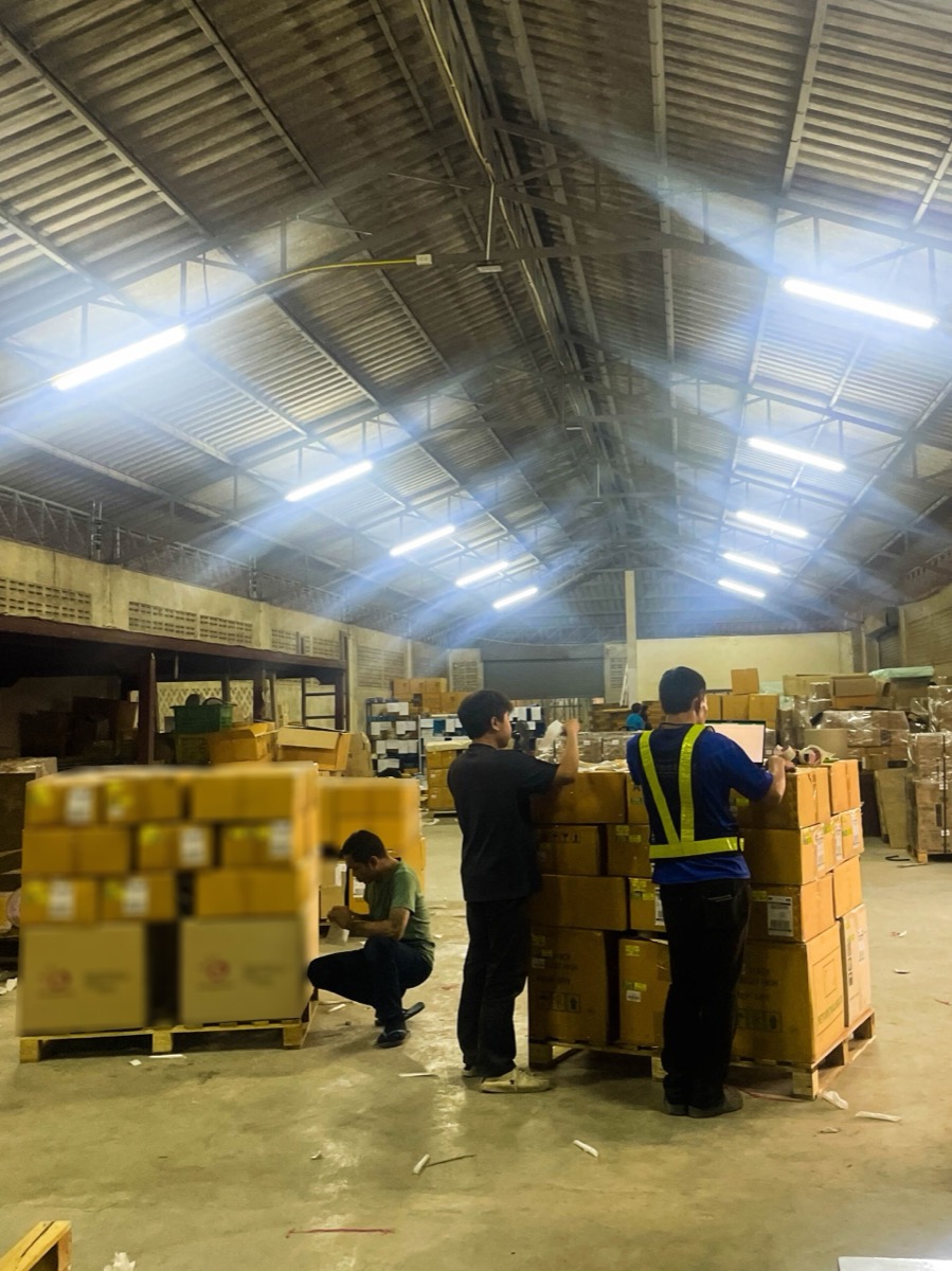 Warehouse team checking palletized freight on the floor